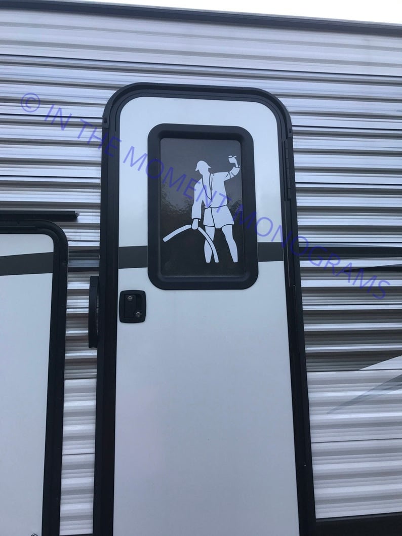 May include: A white door with a black frame and a black handle. A small window with a black frame is in the center of the door. A silhouette of a person holding a hose is visible in the window.