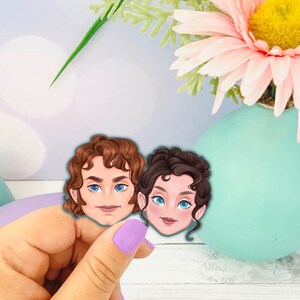 May include: Two cartoon faces of a couple, a man with brown hair and a woman with brown hair, are shown on a white background. The man has brown eyes and a brown mustache. The woman has blue eyes and a pink blush on her cheeks.