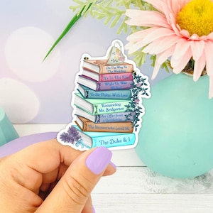May include: A stack of eight paperback books with colorful covers featuring titles from the Bridgerton series. The books are arranged in a stack with the title "The Duke & I" on the bottom and "On The Way To The Wedding" on the top.