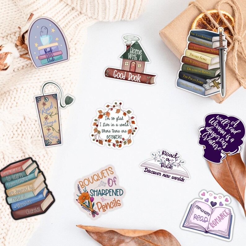 May include: A set of 10 book-themed stickers featuring various designs, including a house with the text "Home With A Good Book", a stack of books with a sword, a wreath with the text "I'm so glad I live in a world where there are Octobers", a book with the text "Read a Book Discover New Worlds", and a bouquet of sharpened pencils.