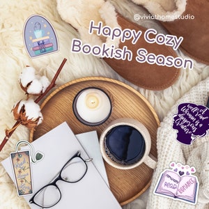 May include: A cozy scene with a tray of coffee, a candle, and books. There are several stickers with book-themed quotes, including "Well read woman is a dangerous creature" and "February read romance".