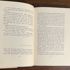 May include: A book open to a page with the title "Chapter 5" and text about a family preparing for a church meeting. The text describes a disagreement between a woman and her uncle about her clothing choices.