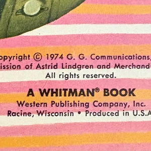 May include: A book page with horizontal pink and orange stripes featuring black text that reads: Copyright 1974 G. G. Communications, Inc. with permission of Astrid Lindgren and Merchandising Munich. All rights reserved. A WHITMAN BOOK Western Publishing Company, Inc. Racine, Wisconsin Produced in U.S.A.
