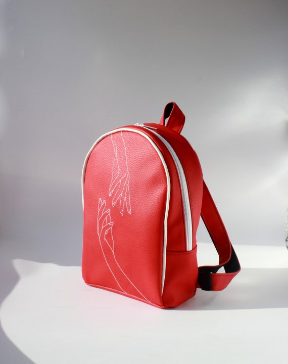 red faux leather backpack