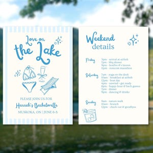 May include: A blue and white striped invitation for a hen party on the lake. The invitation says "Love on the Lake" and includes a drawing of a swimsuit, a glass of champagne, and a deckchair. The invitation also includes the text "Please join us for Hannah's Hen Do, Muskoka, ON | June 6-8". The back of the invitation lists the weekend details, including arrival time, activities, and meal times.