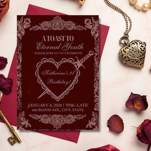 May include: A burgundy invitation card with ornate floral borders and the text "A Toast to Eternal Youth." The card features a heart pierced by a dagger, with the text "Katherine's 21st Birthday!" Gold key and heart-shaped pendant are also visible.