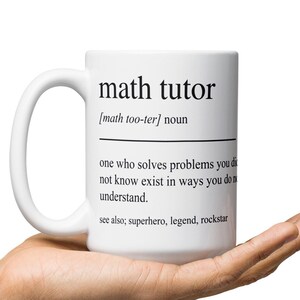 Op de afbeelding: Een witte keramische mok met een zwarte afbeelding waarop staat: "math tutor [math too-ter] noun one who solves problems you don't know exist in ways you don't understand. see also; superhero, legend, rockstar"