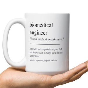 May include: White ceramic mug with a black design that reads "biomedical engineer [bay-oh-med-i-kal en-juh-neer] one who solves problems you did not know exist in ways you do not understand. see also, superhero, legend, rockstar"
