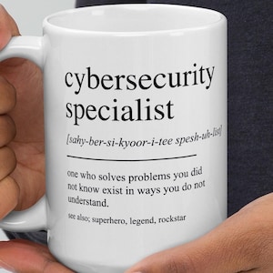 May include: White ceramic mug featuring the text "cybersecurity specialist" in black, with a definition and phonetic pronunciation. The mug also includes a description of the role. A perfect gift for a cybersecurity professional.