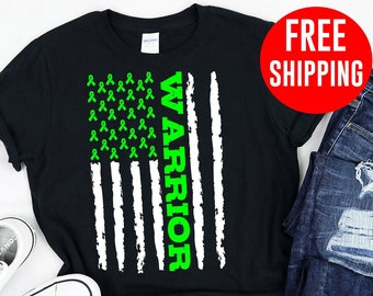 May include: Black t-shirt with a green ribbon American flag design and the word "WARRIOR" printed vertically on the right side of the flag.