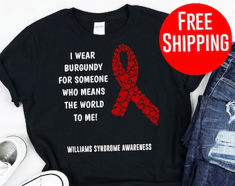 May include: Black t-shirt with a red ribbon made of hearts and the text "I wear burgundy for someone who means the world to me! Williams Syndrome Awareness".