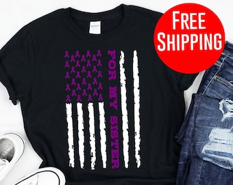 May include: Black t-shirt featuring a purple ribbon American flag design with the text "For My Sister".