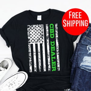May include: Black t-shirt with a distressed American flag design and the text "CBD DEALER" in green letters.