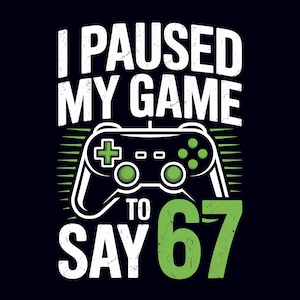 May include: Black t-shirt with a white and green graphic. The graphic features a game controller and the text "I PAUSED MY GAME TO SAY 67". The design has a distressed, vintage look.