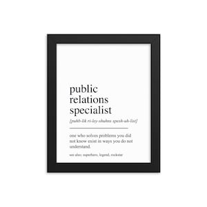 May include: Black and white printable wall art with a definition of "public relations specialist" in a black frame. The definition reads: "one who solves problems you did not know exist in ways you do not understand. See also: superhero, legend, rockstar."
