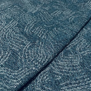 May include: A dark blue fabric with a textured weave and a subtle, repeating tonal pattern. The material features a dense, interlaced construction with visible fibers that create a slightly raised surface effect across the entire textile.