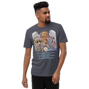 May include: A dark heather grey t-shirt with a stained glass image of three people. The image is surrounded by a white halo. The text below the image reads: "Ahmaud Arbery killed while jogging on February 23, 2020. Breonna Taylor killed by police March 13, 2020. George Floyd killed by police May 25, 2020."
