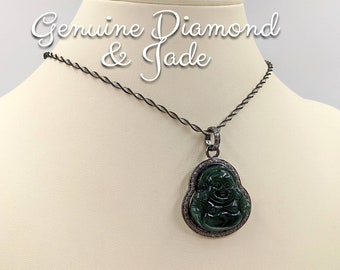May include: A silver chain necklace with a jade Buddha pendant surrounded by a halo of small diamonds. The pendant is green and the diamonds are clear. The necklace is on a white mannequin.