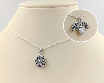 May include: A silver necklace with a sunflower pendant that opens to reveal the words "My Sunshine".