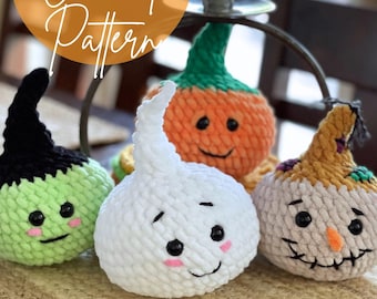 May include: Four crocheted Halloween characters: a green monster, a white ghost, an orange pumpkin, and a brown scarecrow. The characters have smiling faces and are arranged on a woven surface. The image includes the text "4 IN 1 Crochet Pattern".
