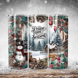 May include: Three stainless steel tumblers with a winter scene design. The tumblers feature a snowman, a snowy cabin, and a Christmas tree. The text "I will Praise Him in Every Season" is printed on the middle tumbler.