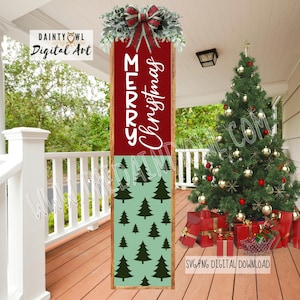 May include: A wooden Christmas sign with the words "MERRY Christmas" in white script on a red background. The bottom section has a green background with black Christmas tree silhouettes. The sign is decorated with greenery and a red bow.