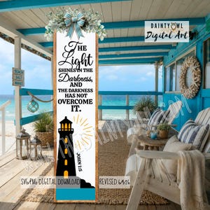 May include: A vertical wooden sign featuring a white background with black text that reads, The Light Shines In The Darkness, And The Darkness Has Not Overcome It, John 1:5. A black lighthouse graphic with yellow light and a blue base is included.