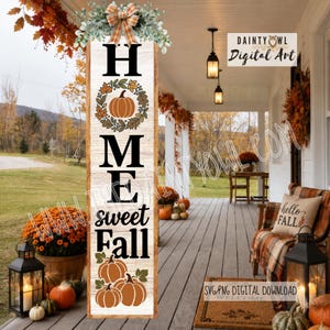 May include: A vertical wooden porch sign with a white wood grain finish featuring the black text HOME sweet Fall. The design includes a pumpkin wreath around the letter O, a cluster of pumpkins at the bottom, and a plaid bow with greenery at the top.