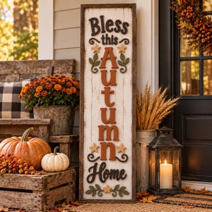 May include: A tall rectangular wooden sign with a distressed white finish and a dark brown frame. The sign features the text Bless this Autumn Home in raised dark brown and orange lettering, accented with small wooden stars and green leaf motifs.