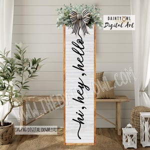 May include: A long, rectangular wooden sign with the words "hi, hey, hello" in black script. The sign has a white, weathered background and a brown frame. It is decorated with greenery and a striped bow at the top. The sign is a decorative item.