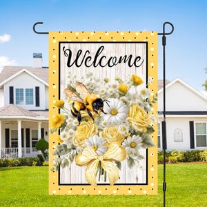 May include: A yellow and black bee with a white and yellow flower bouquet on a white wood background with a yellow polka dot border. The text "Welcome" is written in black on a white background.