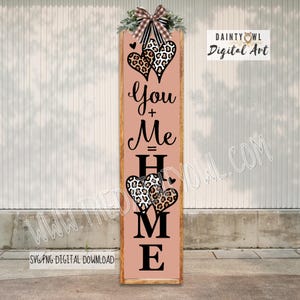May include: A vertical wooden sign with a pink background and the words "You + Me = HOME" in black script. Two leopard print hearts are at the top and bottom. The sign is decorated with greenery and a plaid bow. The text "DAINTY OWL Digital Art" is in the upper right corner.