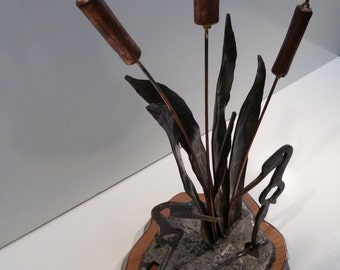 Unique hand forged Sculpture of two Cranes among Cat Tails on hammer textured repurposed Railroad Track Plate mounted on Cherry base