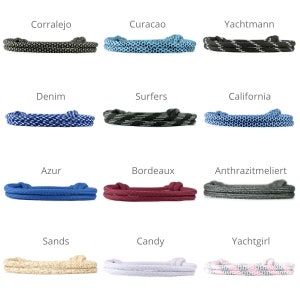 May include: Twelve different colors of paracord bracelets with various patterns. The bracelets are made of two strands of paracord and are tied with a knot at the end. The colors include black, blue, red, white, pink, and beige.