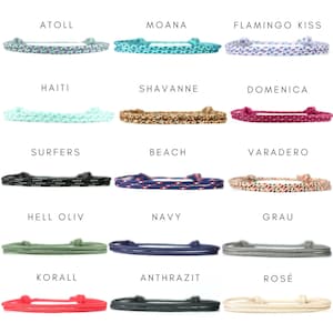 May include: A collection of fifteen braided cord bracelets in various colors and patterns, each labeled with names including Atoll, Moana, Flamingo Kiss, Haiti, Shavanne, Domenica, Surfers, Beach, Varadero, Hell Oliv, Navy, Grau, Korall, Anthrazit, and Ros&eacute;.