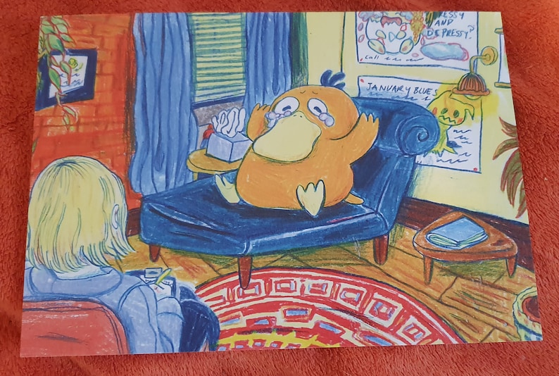 May include: A cartoon illustration of a yellow duck-like creature sitting on a blue couch with a box of tissues. The creature is crying and has a sad expression. The couch is in a room with a yellow wall and a red rug. The text "JANUARY BLUES" is written on the wall.