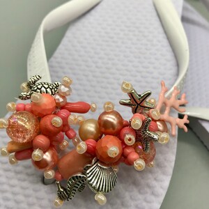 Coral Beads and Beach Charms on White Flip Flops.