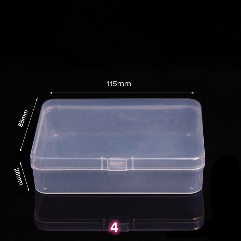 May include: A clear plastic storage box with a hinged lid. The box measures 4.5 inches long, 3.3 inches wide, and 1.1 inches tall.