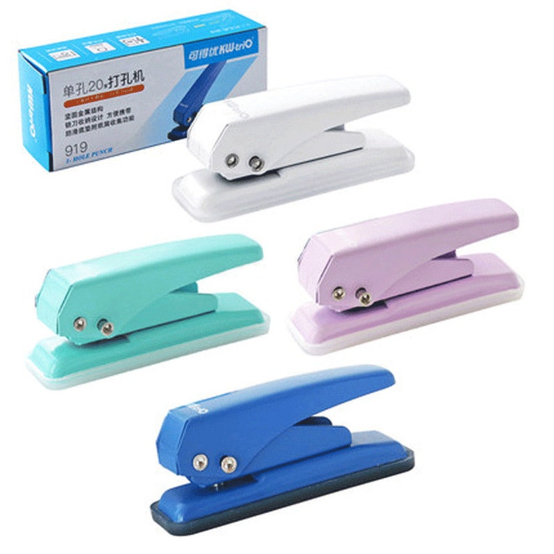 May include: Four single-hole punchers in different colors: white, light blue, light purple, and blue. The punchers are all the same size and shape, with a small metal lever on the top. The punchers are all sitting on a white surface.
