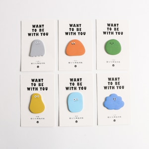May include: Six colorful sticky notes with the text "Want to be with you" and a cartoon character on each. The characters are a ghost, a blob, a cloud, a yellow blob, a blue blob, and a green blob.