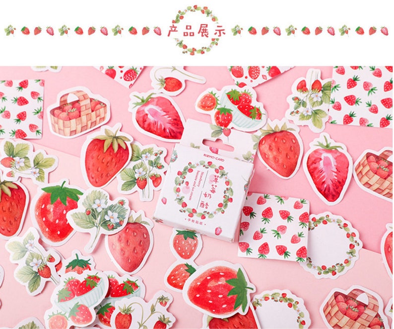 K&ouml;nnte beinhalten: Eine Blatt mit bunten Aufklebern mit Illustrationen von Erdbeeren, Bl&auml;ttern und Blumen. Die Aufkleber befinden sich auf einem rosa Hintergrund. Der Text auf der Aufkleberbox lautet "Strawberry and Cream".