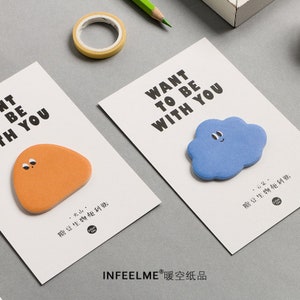May include: Two white cards with the text "Want to be with you" and a cute cartoon cloud and a brown blob sticker. The text "INFEELME 暖空纸品" is at the bottom of the cards.