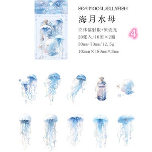May include: A sheet of 20 decorative stickers featuring blue and white watercolor jellyfish, a bottle with a cork, and a seashell. The stickers are 1.97 inches to 2.76 inches in size and come in a pack of 10 designs. The stickers are labeled "Sea Moon Jellyfish" and "海月水母" in Japanese.