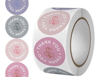 Può includere: Un rotolo di adesivi rotondi con un motivo floreale e la scritta "THANK YOU" disposta a cerchio. Gli adesivi sono in tonalità di rosa, viola e grigio. Il rotolo è bianco.