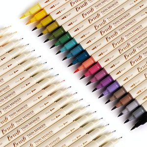 May include: A collection of colorful twin markers with brush and fine tips. The markers are arranged diagonally, showcasing a range of vibrant colors including yellow, green, blue, red, and purple. Each marker is labeled with the text "Brush TWIN MARKER Water Based Ink/Blendable".