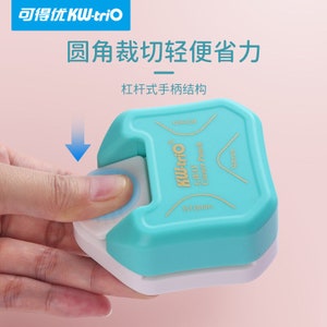 May include: A blue and white corner rounder punch with a lever handle. The punch is labelled "KW-trio 3-WAY Corner Punch" and has measurements of "R10mm" and "R4mm".