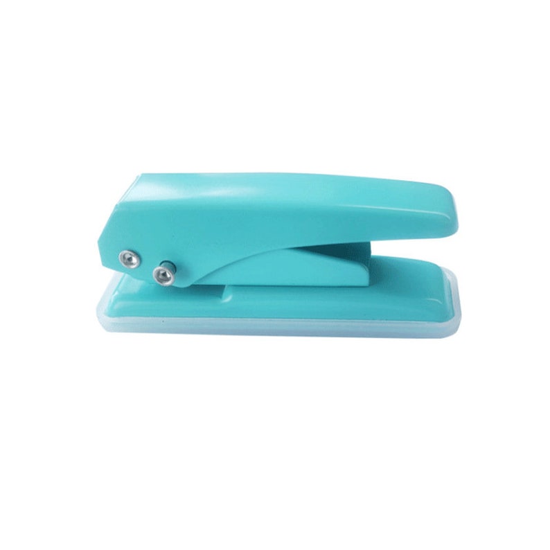 May include: A turquoise blue handheld paper punch with a white base. The punch has a lever on top and two metal holes for punching.