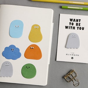 May include: A set of colorful sticky notes featuring cartoon characters with different expressions. The notes are shaped like clouds, ghosts, and other whimsical figures. The text on the card reads "Want to be with you".