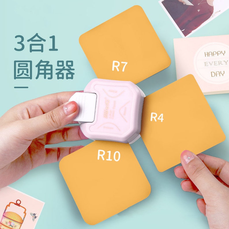 May include: A pink and white paper punch with three different shaped punches. The punches are labelled R7, R4, and R10. The punch is being used to punch out shapes from orange paper.