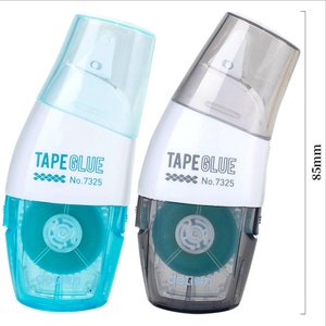 May include: Two tape glue dispensers, one blue and one grey, with the text "TAPE GLUE No.7325" on each. The dispensers are 21.6 cm tall.